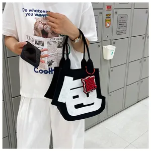 Creative felt tote bag with funny Chinese character design, casual black handbag for daily use.