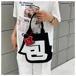 Creative novelty felt handbag featuring unique character design for casual daily commuting style.