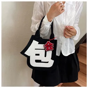 Creative felt handbag featuring abstract design and striking lettering for trendy daily wear.