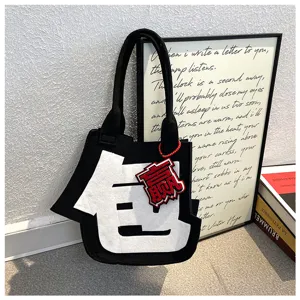 Creative Chinese character felt tote bag, casual black handbag with red pendant, unique detail view.