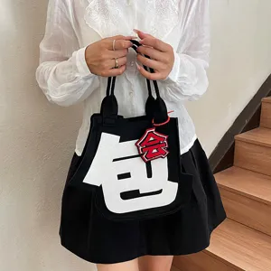 Creative felt handbag with funny character design, stylish casual tote bag for daily commute style.