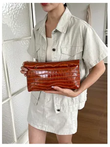 Stylish brown crocodile pattern leather clutch bag, elegant and versatile daily accessory detail.