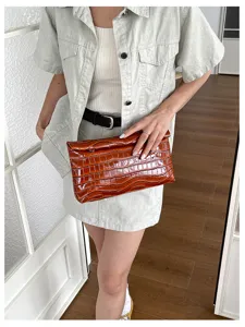 Brown crocodile pattern clutch bag for women, stylish leather purse for daily work commute.