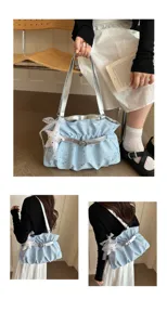 Stylish light blue ruched shoulder bag with silver straps and cute star pendant accessory.