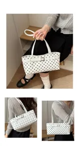 Stylish white polka dot underarm shoulder bag for women, chic commuting handbag with belt buckle.