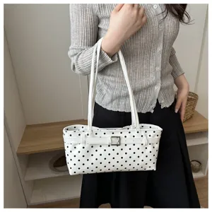 White polka dot shoulder bag detail, stylish underarm handbag for women, daily commuter style.