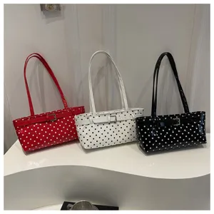 Polka dot shoulder bag detail, glossy patent leather texture, elegant belt buckle accessory.