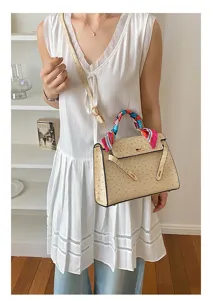 Chic ostrich textured Kelly handbag with colorful silk scarf handle, elegant shoulder bag for women.