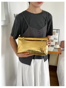 Stylish metallic gold crocodile pattern clutch bag for women, elegant evening purse daily.