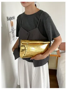 Elegant metallic gold crocodile pattern clutch bag for women, chic minimalist evening purse.