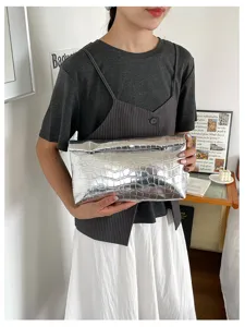 Silver metallic crocodile pattern clutch bag, chic minimalist envelope design for women.