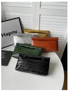 Detailed view of fashionable faux crocodile texture clutch bags in multiple vibrant metallic colors.