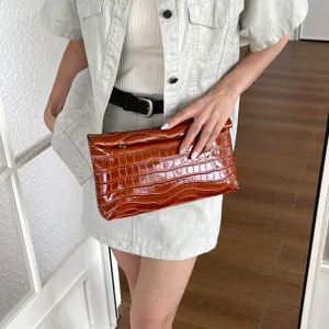 Stylish brown crocodile pattern leather clutch bag, minimalist daily casual fashion accessory.