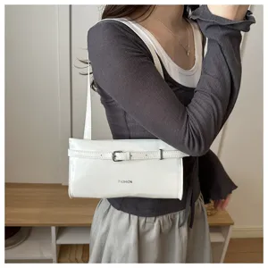 White patent leather shoulder bag for women, stylish underarm bag with belt buckle design.