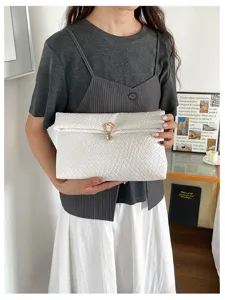 Stijlvolle witte geweven clutch tas voor dames met een chique goudkleurige metalen slot.