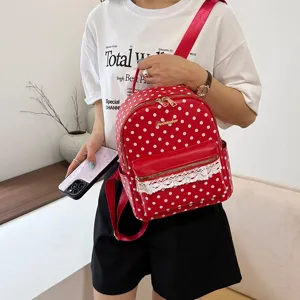 Red polka dot canvas backpack for women, stylish casual travel bookbag with lace trim.