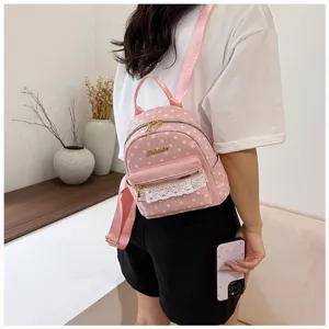 Pink polka dot mini backpack for women, stylish casual daypack with cute lace pocket details.