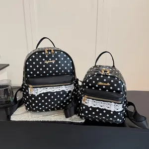 Black and white polka dot backpack with cute lace trim, casual student school bag for daily use.