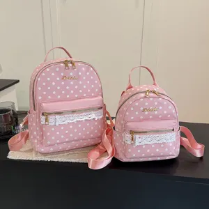 Pink polka dot backpack with lace trim, cute casual daypack for women and girls daily use.