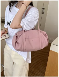 Casual pink tote shoulder bag for women, large capacity daily commuter handbag with stylish design.