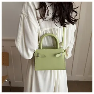 Minimalist green mini crossbody bag, chic shoulder bag detail, stylish daily accessory.