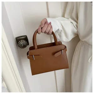 Minimalist brown small square bag detail, elegant tote handbag with side strap buckle design.
