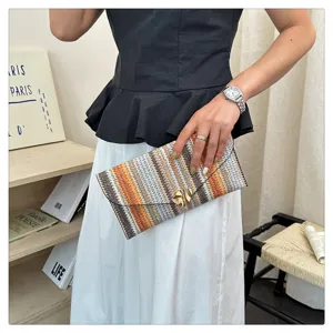Colorful woven striped envelope clutch bag featuring chic multi-color fabric and metal clasp.