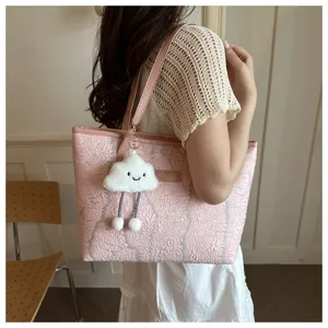 Pink textured tote bag with cute cloud charm, stylish large commuter shoulder bag for women.