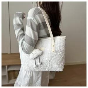 Casual white textured tote bag with cute cloud pendant, stylish shoulder bag for daily commuting.