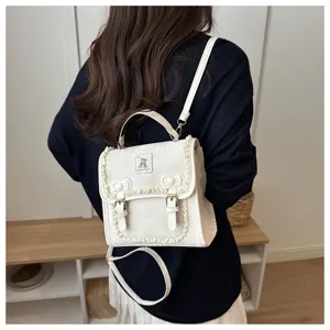 Detailed view of the white sweet lace mini backpack, showing cute bow and bear badge design.