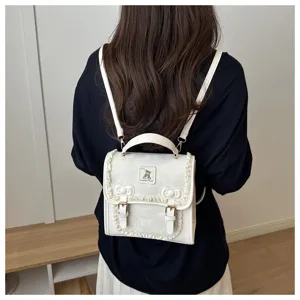 Detail view of a sweet white mini backpack featuring lace trim and cute bow. Stylish daily wear.
