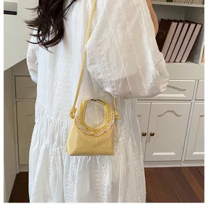 Chic mini crossbody bag with delicate lace trim, trendy yellow PU leather handbag for women.