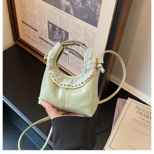Green PU leather mini crossbody bag with chic lace ruffle handle for trendy daily wear.