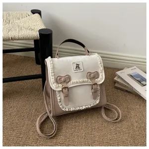 Sweet style small backpack for women, featuring cute lace trim, double bows, and chic bear patch.