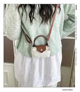 Chic small crossbody handbag for women, stylish star pattern design with top handle and strap.