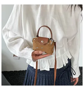 Detail view of the stylish mini crossbody bag with star pattern, compact design and chic strap.