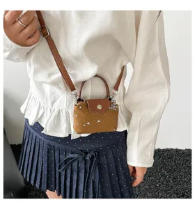 Mini brown square crossbody bag with star prints, cute handheld coin purse detail view.