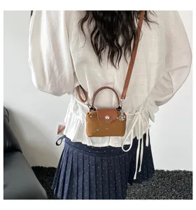Detailed view of women fashion mini square bag with cute stars pattern and shoulder strap.