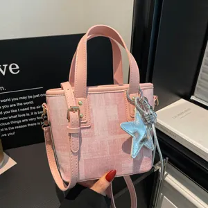 Fashion pink bucket handbag for women, casual commuting shoulder and crossbody bag with stylish star.