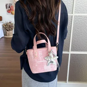 Chic pink bucket bag for women, stylish tweed pattern shoulder bag with star charm.