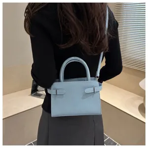Chic light blue mini shoulder bag for women, trendy minimalist crossbody bag with top handle.