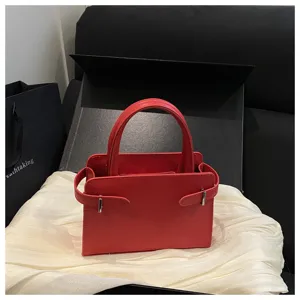 Stylish red square handbag for women, premium leather texture with chic belt design, casual.