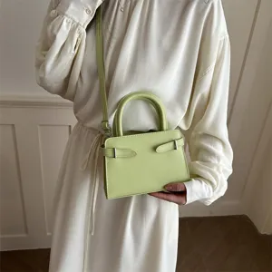 Green minimalist cross body bag for women, stylish small square shoulder handbag.