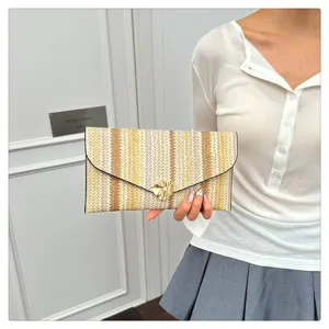 Woven straw striped envelope clutch bag with metal clasp detail in a stylish summer look.
