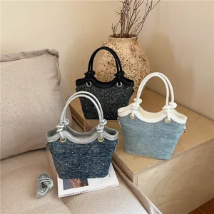 Fashion tweed bucket bag detail, stylish denim handbag with metal rings and shoulder strap.