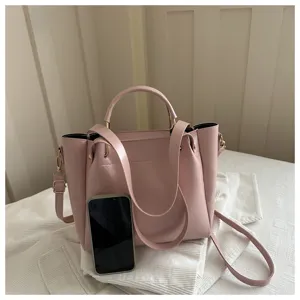 Pink vintage style women bucket shoulder crossbody bag detail view with handle and strap.