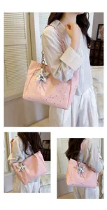 Detailed view of the pink star tote bag, showcasing the unique silver star charm and strap.
