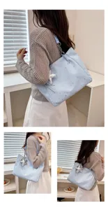 Casual light blue tote bag with star pendant, stylish shoulder bag for daily commute.