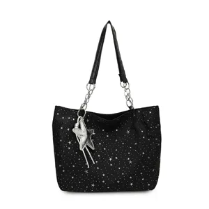 Casual black tote bag for women with silver star print, stylish chain strap and star pendant.