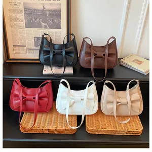 Women's fashion underarm shoulder bag with chic bow design, stylish commuter PU leather handbag.